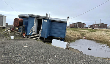 A home in Point Lay that is affected by ice-wedge thermokarst. Credit Benjamin Jones